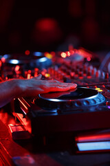 Wall Mural - Party dj playing music in night club with professional cd turntables. Disc jockey mixing musical tracks on concert stage