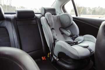 child car seat for safety in the rear passenger seat of a car