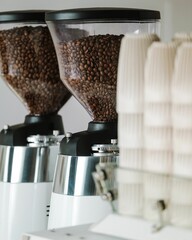 Canvas Print - Vertical closeup shot of two coffee machines filled with coffee beans