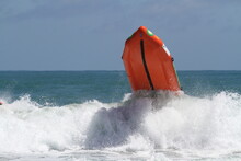 Orange Inflatable Surf Rescue Boat Capsizes