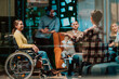 © .shock - Businesswoman in wheelchair having business meeting with team at modern office. A group of young freelancers agree on new online business projects