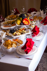  the table in the room is set in red tones with food for the holiday