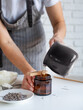 © dark_blade - Woman making decorative aroma candle at table, closeup