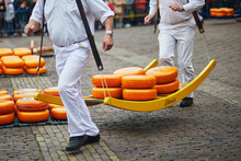 Cheese Carriers Walking With Cheeses At Famous Dutch Cheese Market In Alkmaar