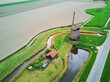 Aerial drone view of traditional Dutch windmill on the field