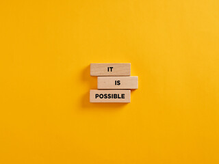 Wall Mural - The motivational message it is possible on wooden blocks. Optimism, positive thinking in business career or education