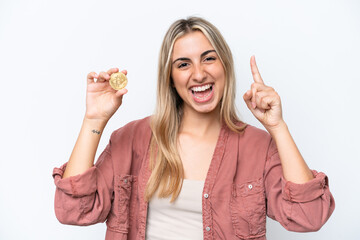 Young caucasian woman holding a Bitcoin isolated on white background pointing up a great idea