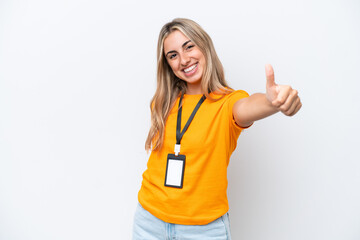 Wall Mural - Young caucasian woman with ID card isolated on white background giving a thumbs up gesture