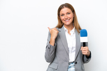 Young caucasian tv presenter woman isolated on white background pointing to the side to present a product