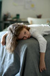 © Mediaphotos - Tired little boy lying on bed in bedroom without mood or he feeling sick