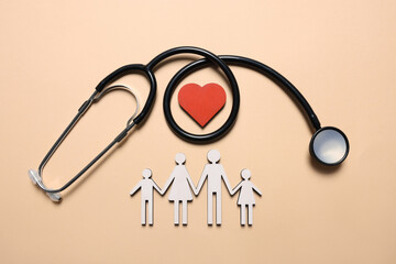  Figures of family, stethoscope and heart on beige background, flat lay. Insurance concept