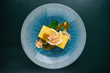 Canvas Print - Raw coconut cream lemon cake garnished with lemon slices, almonds, mint and jam.