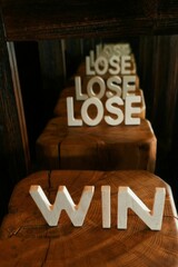Vertical shot of the word win reflecting the word lose
