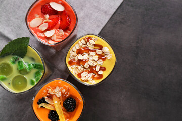 Many different delicious smoothies on grey table, flat lay. Space for text