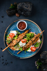 Sticker - Kebab, barbecued chicken on a stick with tomatoes, lettuce, onion, arugula, sour cream, tortilla and red sauce.