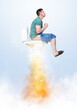 Funny man in a T-shirt and shorts sitting on the toilet flies up like a rocket, leaving smoke and flames behind him. On light background.