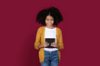 © Prostock-studio - Happy african american girl using digital tablet, studio background