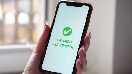 A woman's hand holds a smartphone on screen with the message money sent and received. Concept of financial transactions with mobile devices. Closeup, money, transfer, phone, Payment. Cafe background
