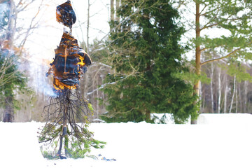 Traditional Russian holiday in early spring. Seeing off winter. Mardi gras. Family with children in the winter in the park.