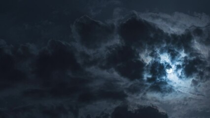 Wall Mural - a dramatic landscape of the night sky. timelapse. there is a full moon in the sky with black clouds 