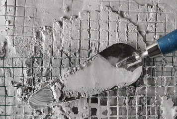 Poster - Wet cement reinforcement with wire mesh and trowel background and texture