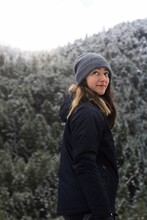 Young Caucasian Female In A Snowy Forest