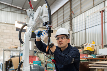 Aufkleber - Male engineers worker working with adept robotic arm in workshop. Male engineer maintenance automatic robotic arm machines in factory. Industry robot manufacturing technology