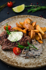 Sticker - Lunch beef steak with mushroom sauce, potato wedges, tomatoes and green peas.