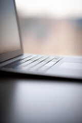 Aufkleber - Close-up of the keyboard of an open laptop ready to work on the table. Side view, selective focus on the keyboard. The concept of computer security and work on the Internet.