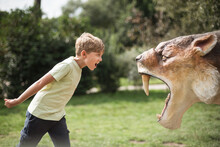 Boy Shouts In Front Of The Saber-toothed Tiger Figure