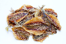Dried Fish With Sesame Seeds On White Background.