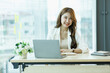 © David - Smiling Cute asian woman working laptop happy for success. Attractive Happy female employee in the office or co-working space with copy space for label text.