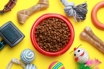 Poster - Flat lay composition with pet toys and feeding bowl on yellow background