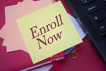 Poster - Enroll Now. Text on adhesive note paper. Event, celebration reminder message.