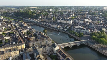 Wall Mural - Scenic drone view of Laval on Mayenne river with ancient massive castle with round keep on sunny summer day, France