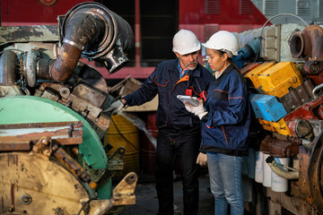 Maintenance manager and engineer checking part large engine supercharger prepare for overhaul repair