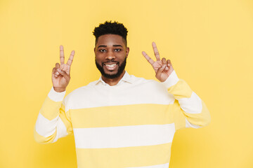 Wall Mural - Happy bearded african american man smiling and gesturing peace sign