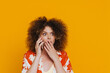 © Drobot Dean - Young beautiful shocked curly woman talking phone covering her mouth