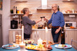 © DC Studio - Romantic couple clinking glasses celebrating their relationship anniversary. Aged couple in love talking having pleasant conversation during healthy meal.