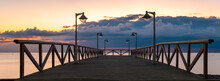 Wooden Pier With Stylish Lamps During Stormy Sunrise