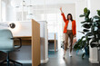 © Westend61 - Happy businesswoman gesturing peace in office