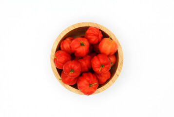 Wall Mural - Top view of fresh cherry Acerola, Barbados Cherry, West Indian Cherry or Wild Crapemyrtle in wooden bowl isolated on white background with clipping path. Scientific name is Malpighia emarginat