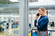 © Westend61 - Businesswoman talking on smart phone by railing in factory