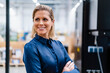 © Westend61 - Smiling businesswoman wearing blue shirt at factory