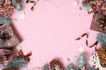 Wall Mural - Frame made frome pine tree branches and Christmas decoration on colored background with copy space