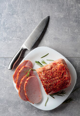 Wall Mural - Smoked ham with rosemary and kitchen knife.