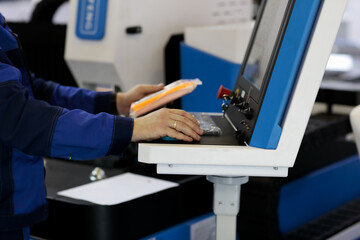 Wall Mural - worker at control console of laser cutting machine