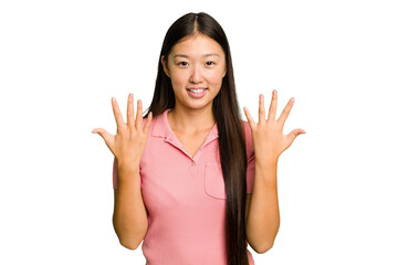 Wall Mural - Young Asian woman isolated showing number ten with hands.