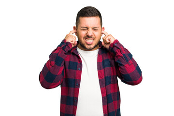 Wall Mural - Young caucasian man isolated covering ears with fingers, stressed and desperate by a loudly ambient.