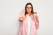 © Asier - Business caucasian woman holding a take away coffee isolated on white background standing with outstretched hand showing stop sign, preventing you.